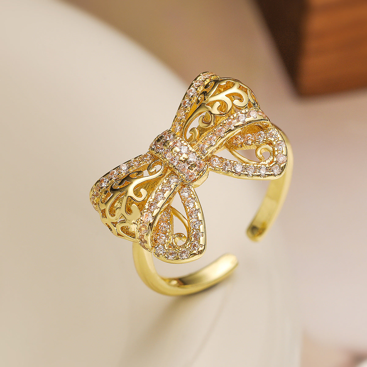 Minimalist Bowknot-Shaped Hollow-Out Copper Ring with 18K Gold Plating and Zircon Inlay for Women