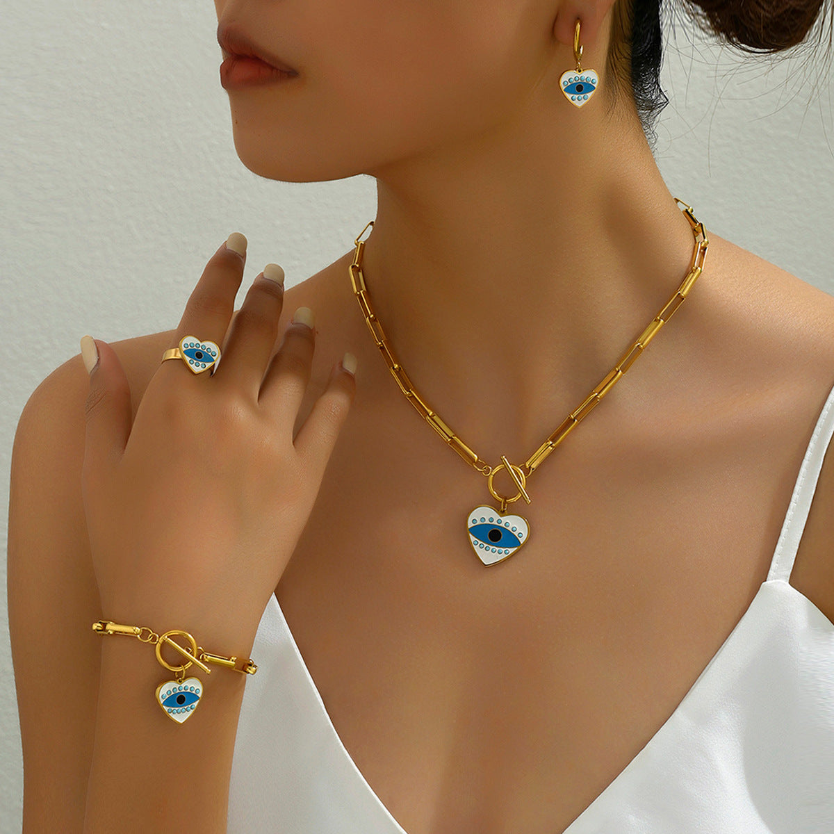 Conjunto de collar, aretes, pulsera y anillo esmaltado de ojo turco con diseño de corazón de moda para mujer