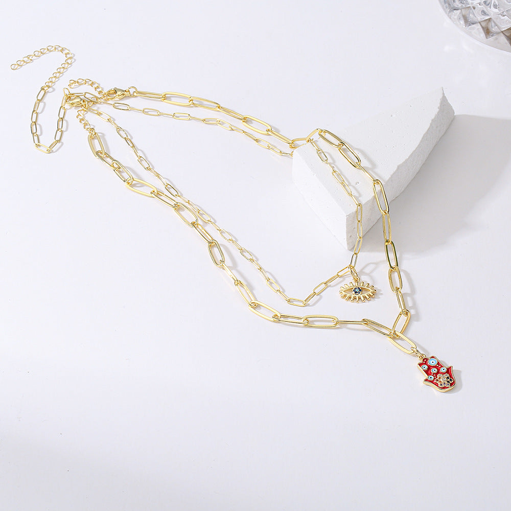 Collana con ciondolo minimalista a mano e occhio per donna in rame con finitura smaltata e intarsi in strass su catena placcata oro 18 carati