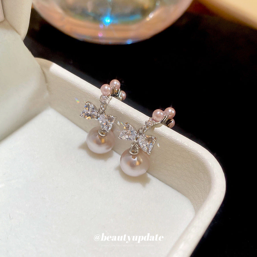Pendientes de botón con forma de lazo y efecto perla de lujo con incrustaciones de circonita para mujer, poste de acero inoxidable, accesorio de moda minimalista