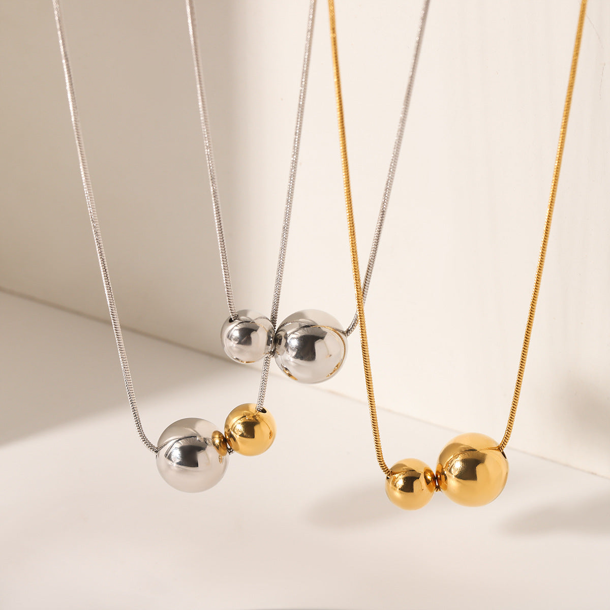 Minimalist Geometric Ball Pendant Necklace in Stainless Steel with Gold and Silver Plated Titanium Steel Accents Snake Chain Collar Jewelry for Women