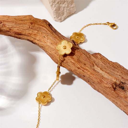 Bracciale da donna in acciaio al titanio placcato oro con motivo floreale alla moda
