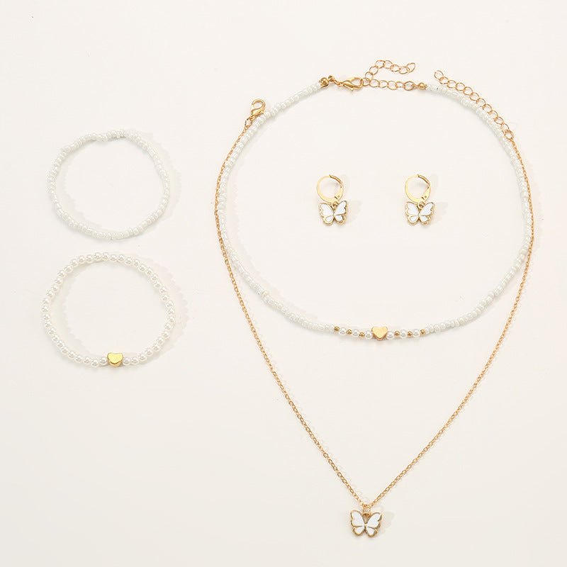 Set collana con ciondolo a farfalla fatto a mano per bambini con perline bianche e ciondolo in lega in stile fresco