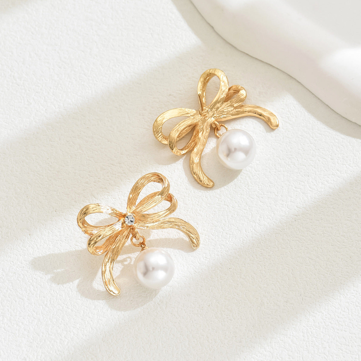 Minimalist Bow-Shaped Alloy Earrings with Pearl Inlay for Women Stainless Steel Post Elegant Everyday Wear