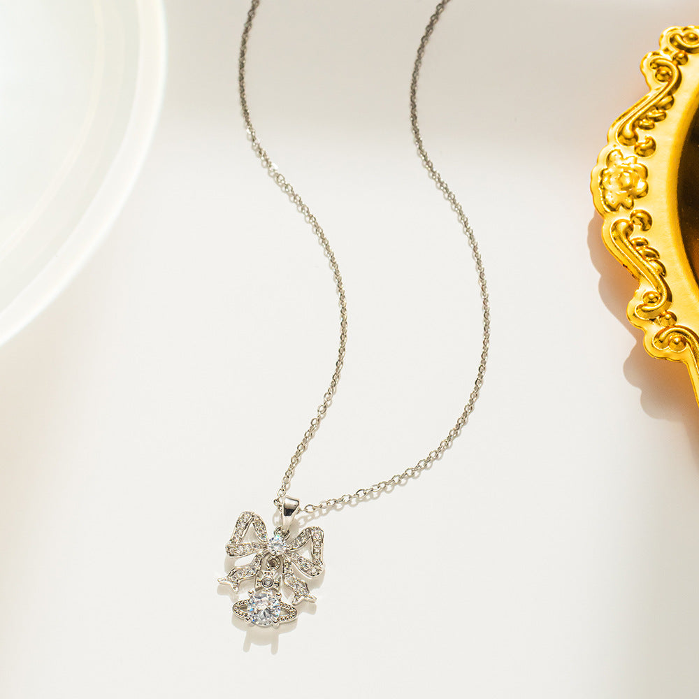 Collana da donna a forma di fiocco minimalista in acciaio al titanio con intarsio di strass, catena a O, delicato gioiello per la clavicola