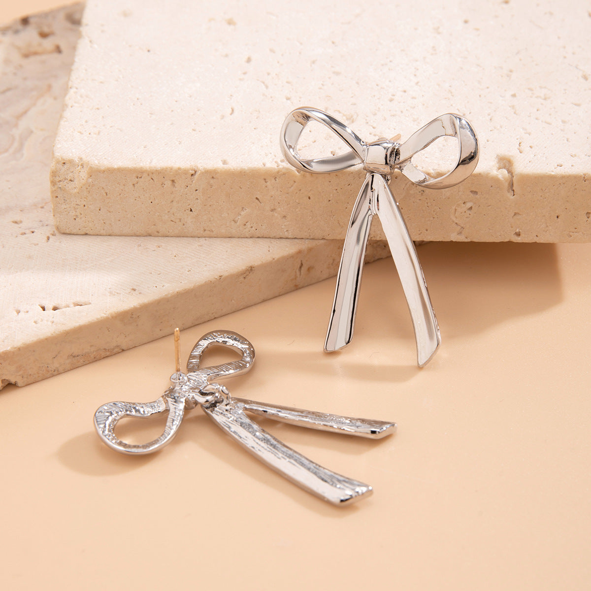 Orecchini a perno da donna a forma di fiocco minimalisti in metallo con finitura galvanizzata