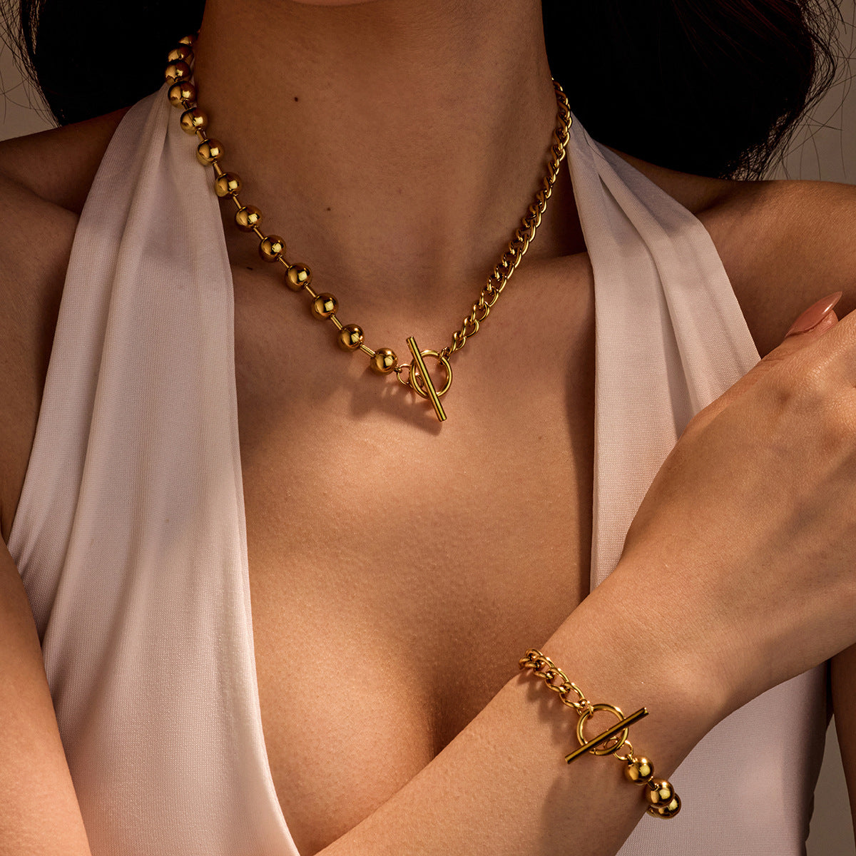 Set di collana e bracciale alla moda da ufficio con perline rotonde e cave in acciaio inossidabile color-block con finitura placcata in acciaio al titanio