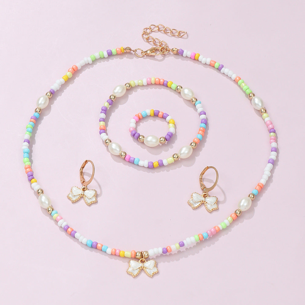 Conjunto de collar, pulsera, anillo y pendientes de aleación con forma de lazo estilo bohemio con acabado esmaltado para niños