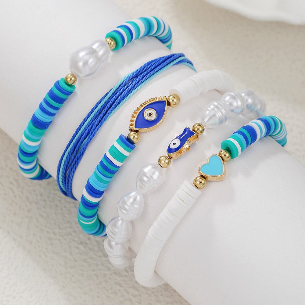 Braccialetto da donna dolce e carino a tema oceano in argilla polimerica e perle con pesci smaltati e occhi a forma di cuore
