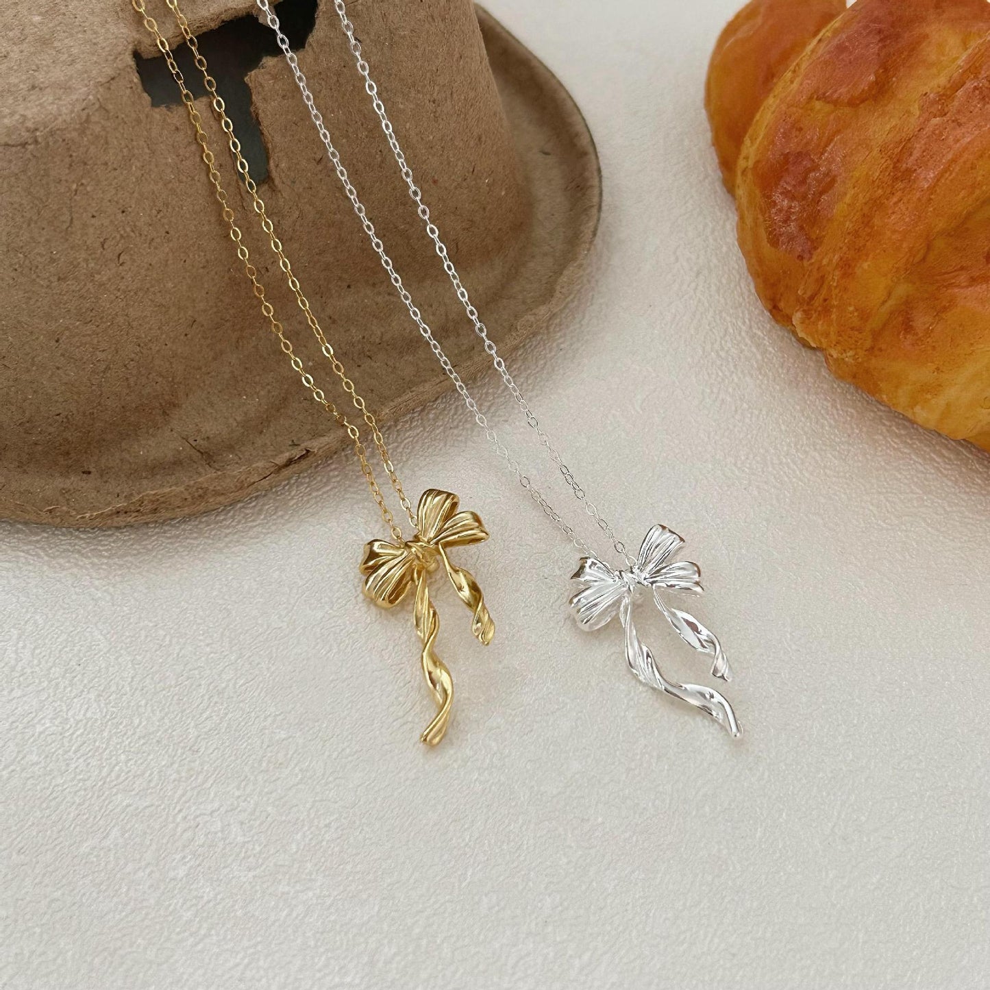 Minimalist Bow-Shaped Pendant Necklace in Sterling Silver with Gold Plating on Cross Chain