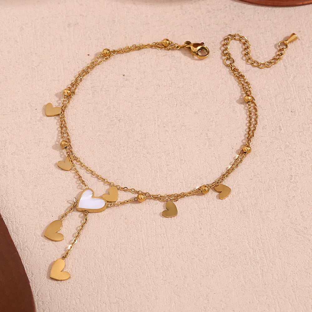 Tobillera Minimalista de Doble Capa con Cadena de Acero Inoxidable, Cuentas Espaciadoras en Forma de Corazón Bañadas en Oro de 18K, Abalone Blanco y Detalles de Borla