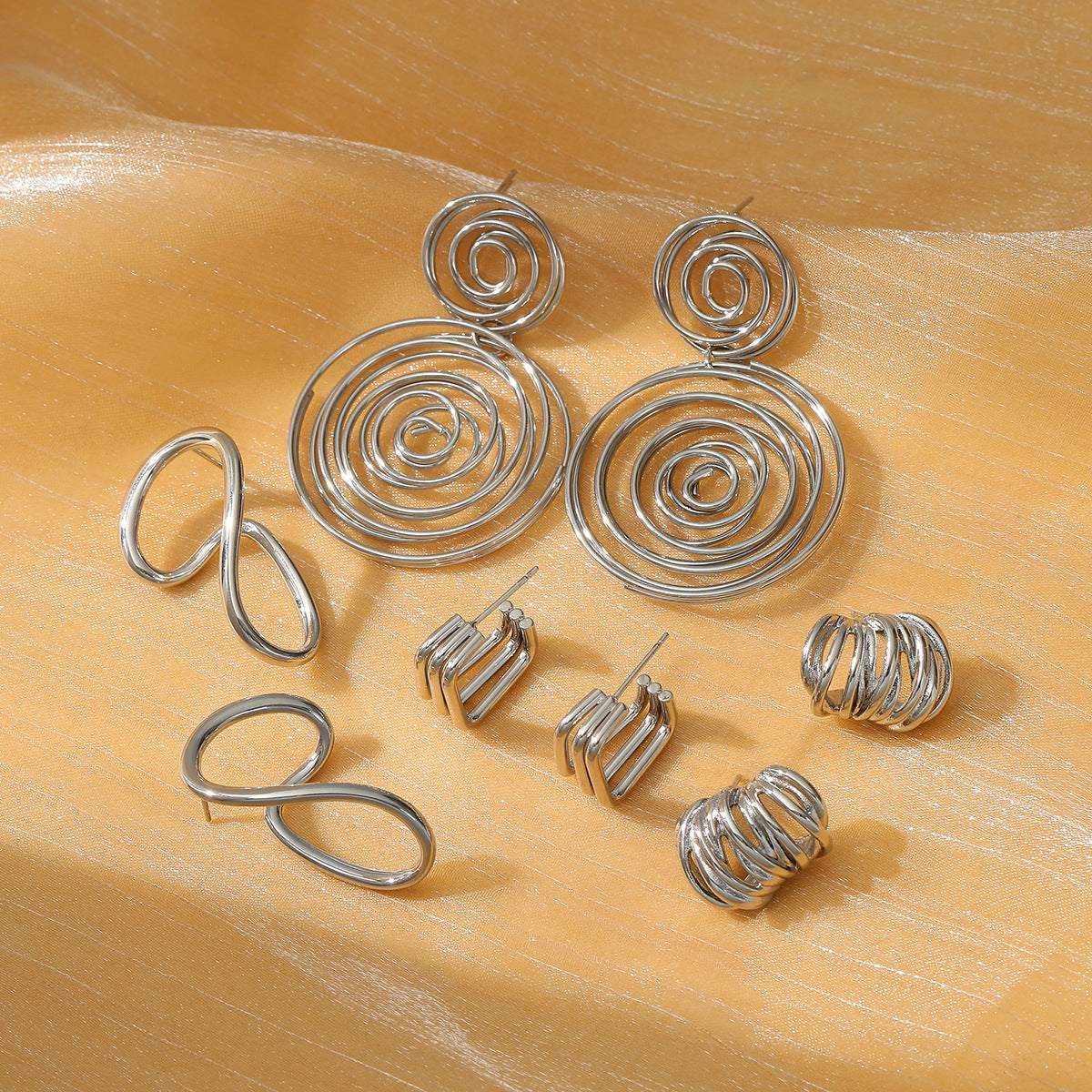 Aretes de titanio con diseño geométrico circular exagerado y acabado galvanizado para mujer