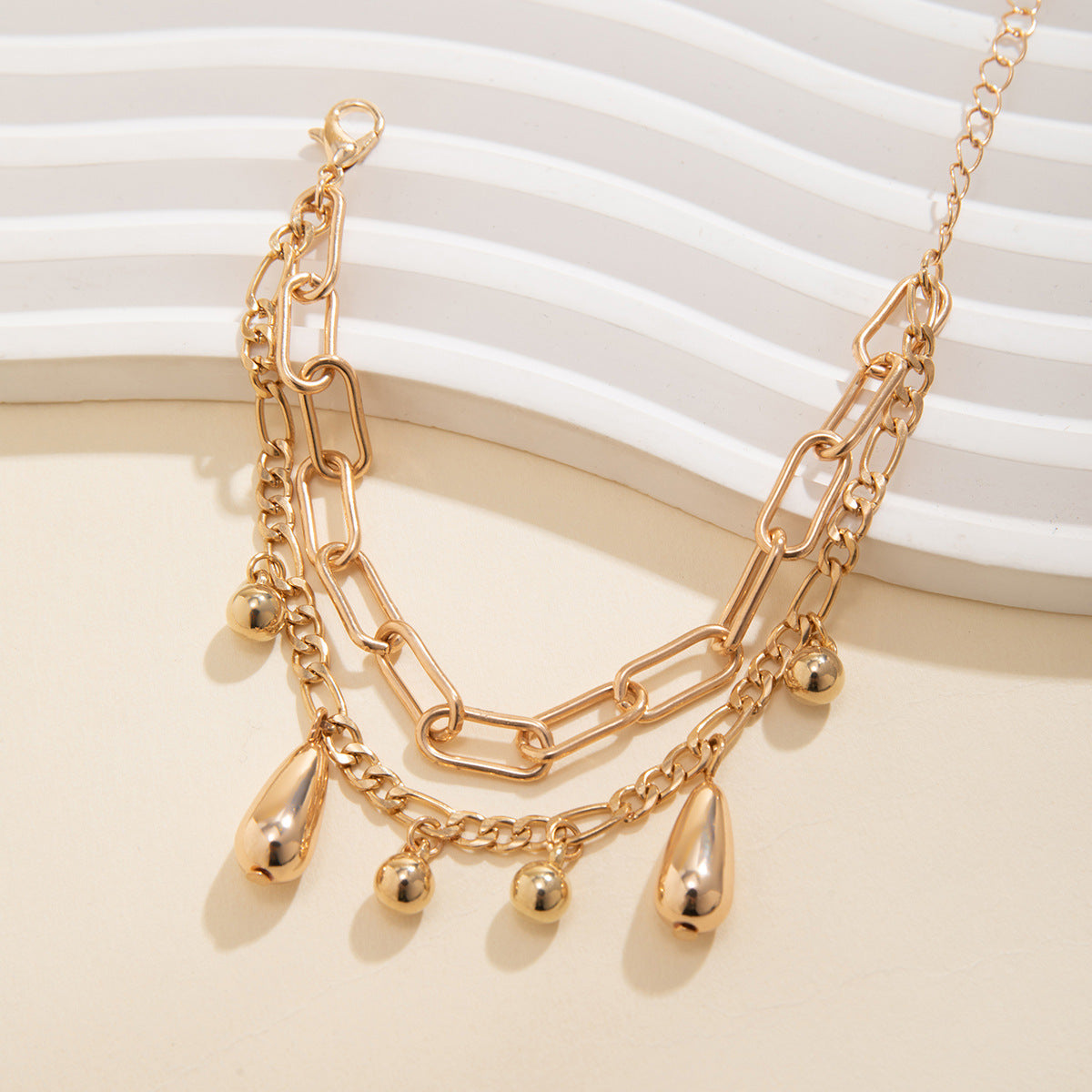 Minimalist Teardrop-Shaped Geometric Pendant Necklace for Women with Plated Metal Chain and Tassel Accents