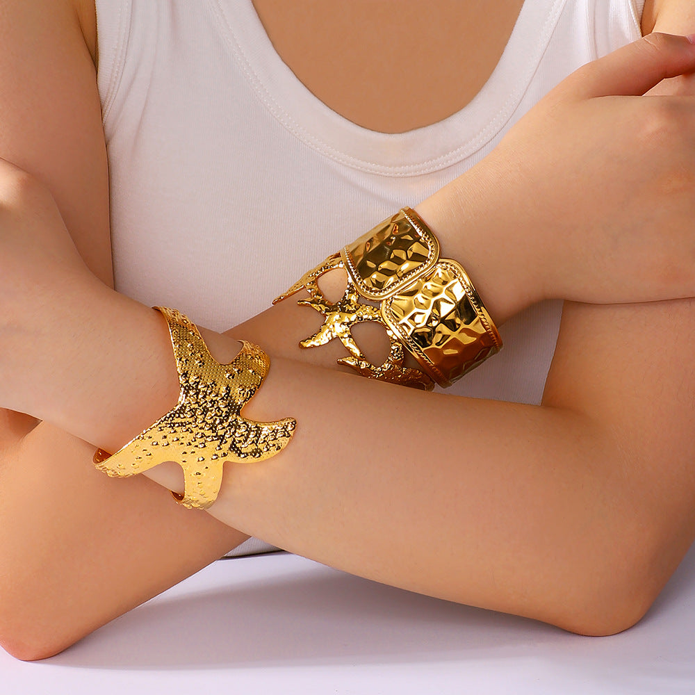 Minimalist Asymmetrical Hollow Flower Starfish Leaf Cuff Bracelet for Women in Titanium Steel with Gold Plating