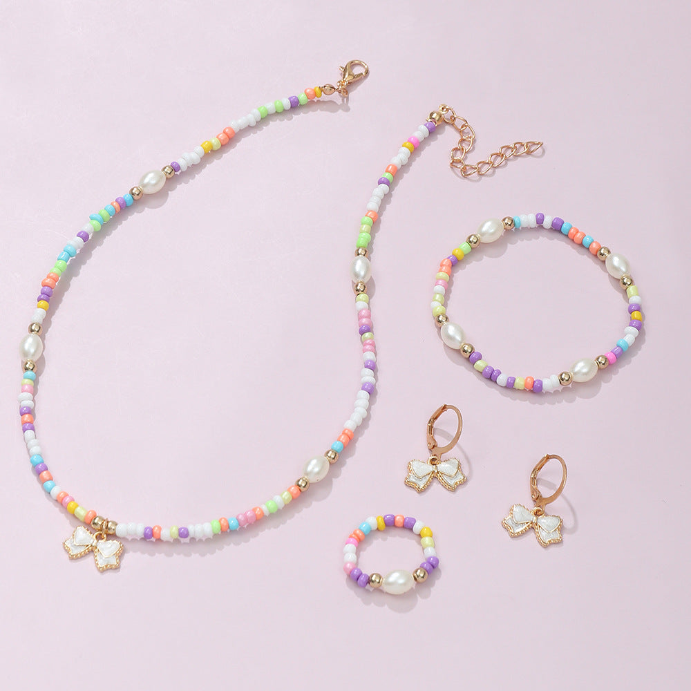 Conjunto de collar, pulsera, anillo y pendientes de aleación con forma de lazo estilo bohemio con acabado esmaltado para niños