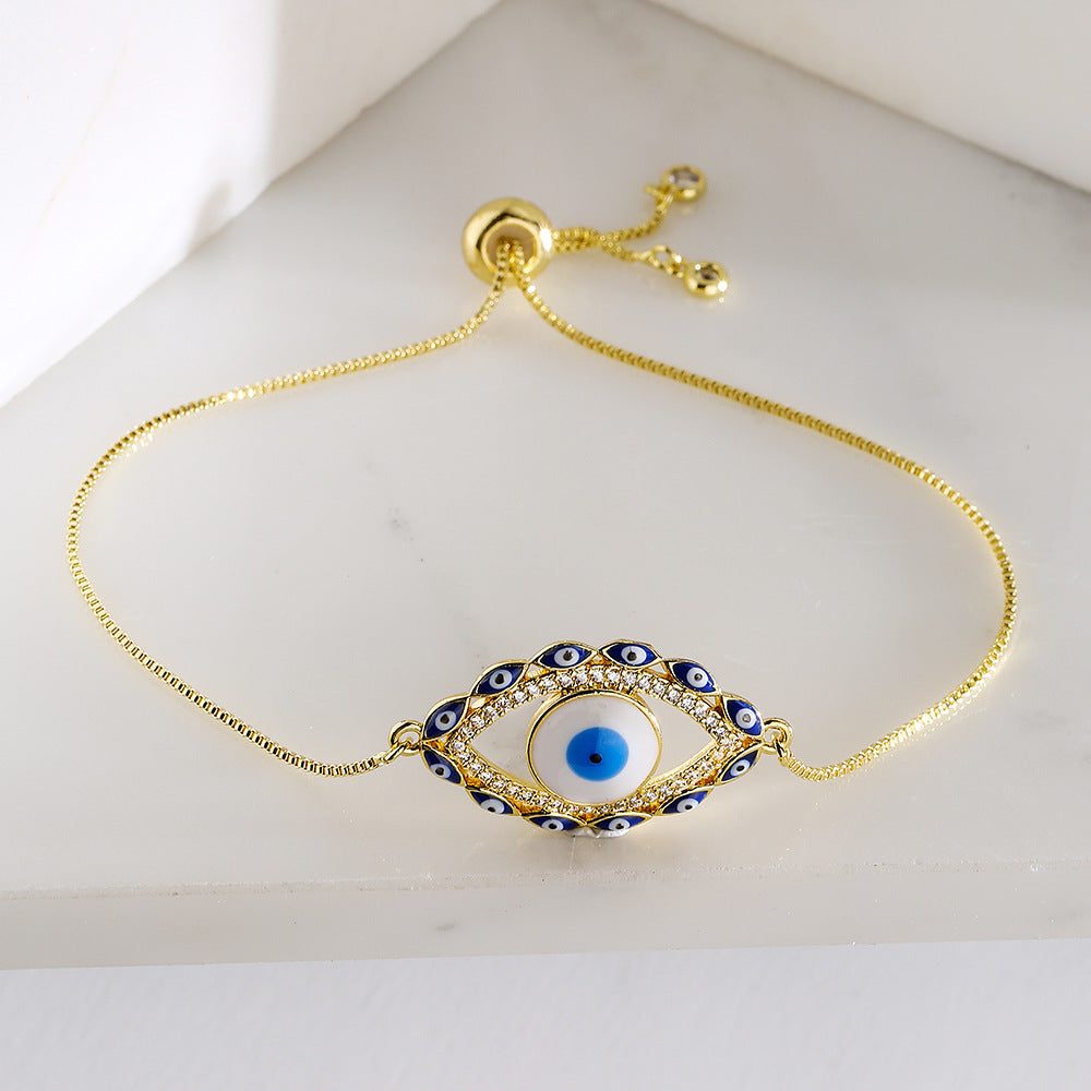 Bracciale da donna stile bohémien con charm a forma di occhio di Nazar, base in rame placcata in vero oro e intarsio di zirconi