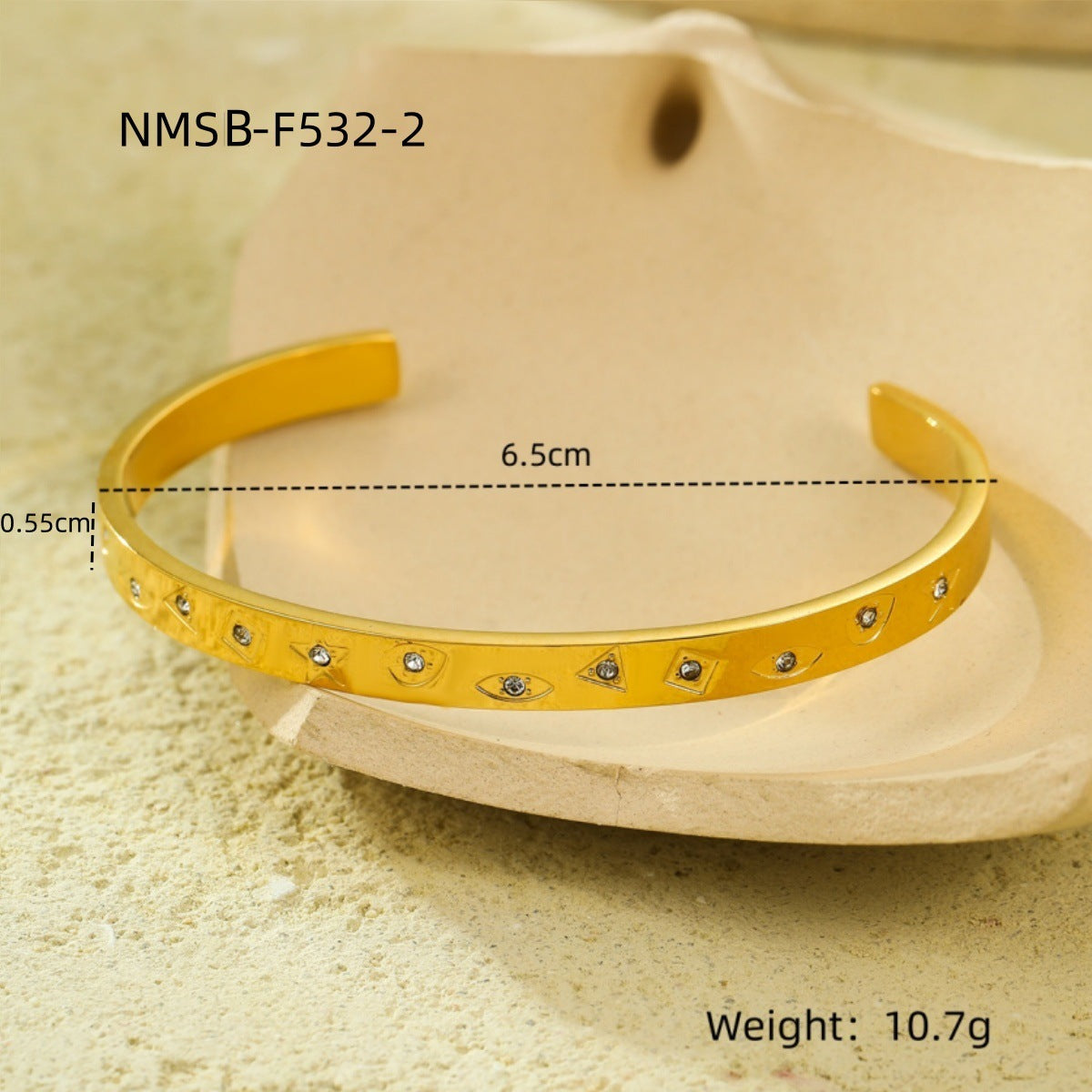 Brazalete abierto de acero de titanio con diseño geométrico, inspirado en el océano, con incrustaciones de pedrería y acabado chapado