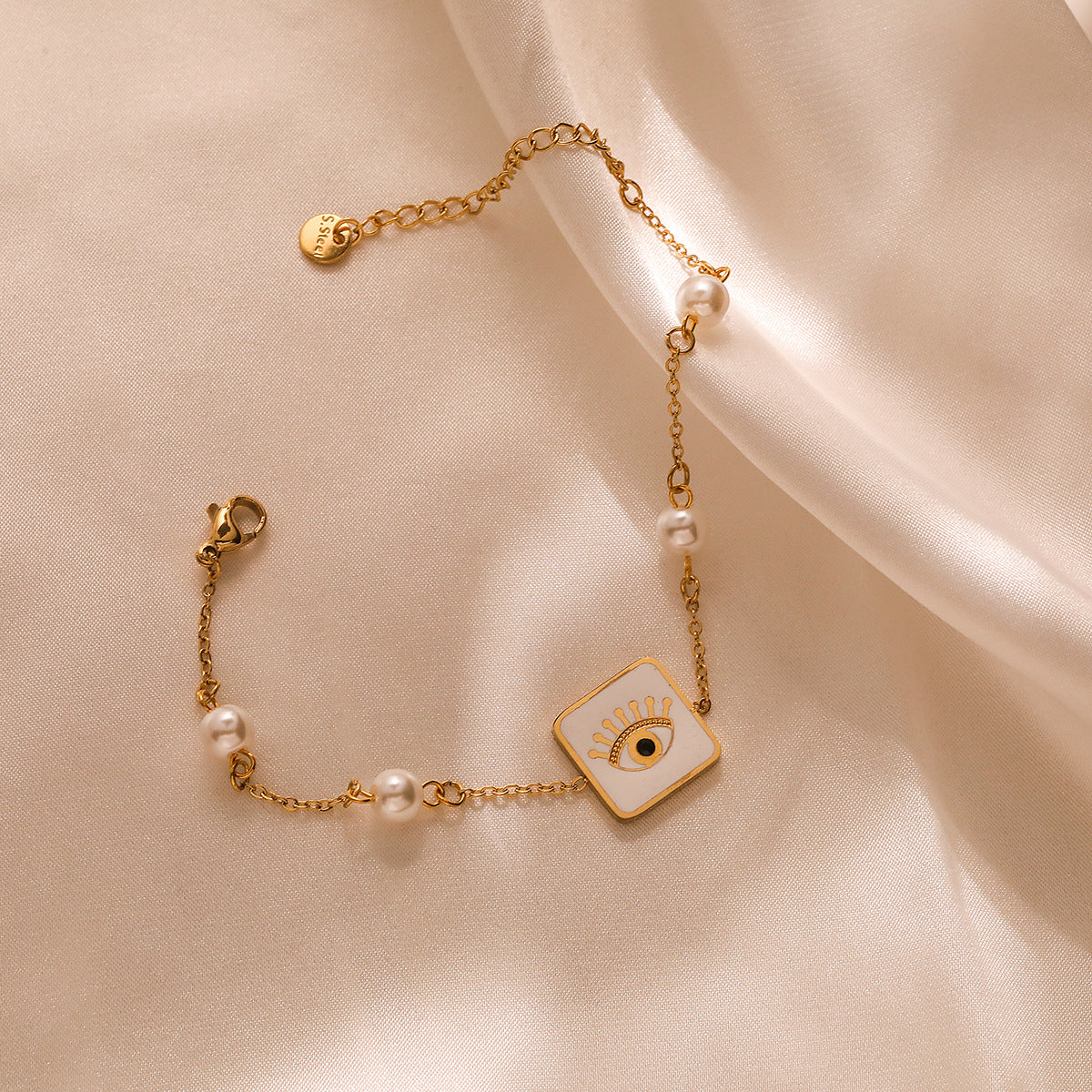 Minimalist Geometric Titanium Steel Bracelet with Gold Plating, Zircon Inlay, and Evil Eye Pendant
