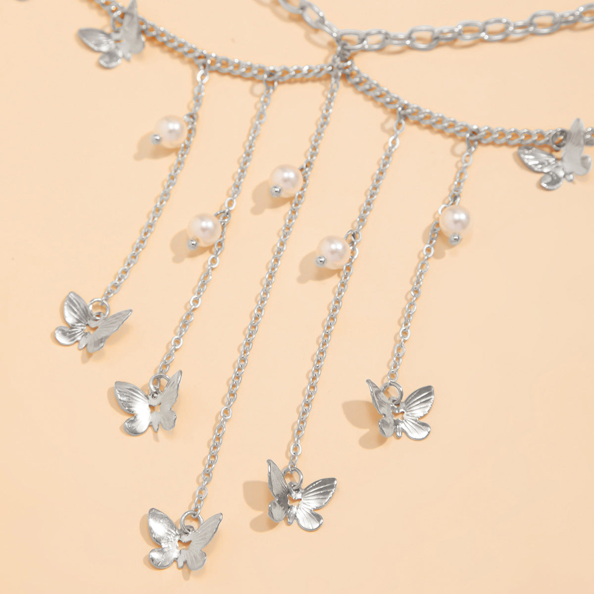 Cadena de cintura metálica minimalista con forma de estrella y mariposa, detalles de perlas y borlas para mujer