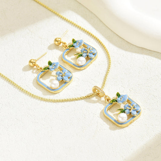 Completo di collana e orecchini floreali alla moda da donna con finitura smaltata e intarsi in perla in rame