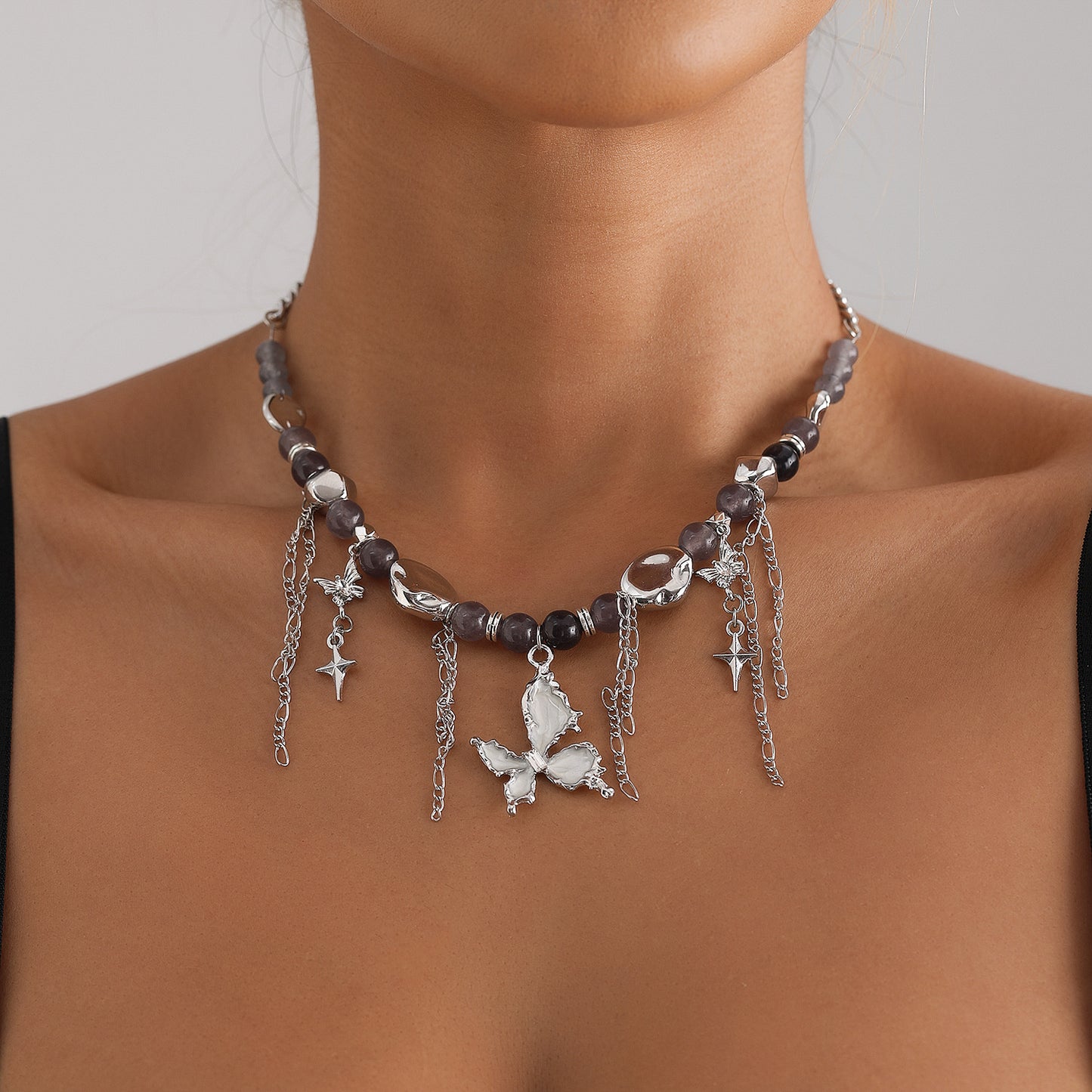 Collar de clavícula con colgante de mariposa esmaltado, incrustaciones de ojo de gato y borlas de estrella de cuatro puntas para mujer