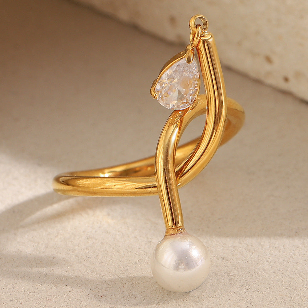 Anillo minimalista de acero inoxidable con chapado en oro de 18 quilates, detalle de nudo, acento de borla, circonita cúbica e incrustación de perlas de imitación