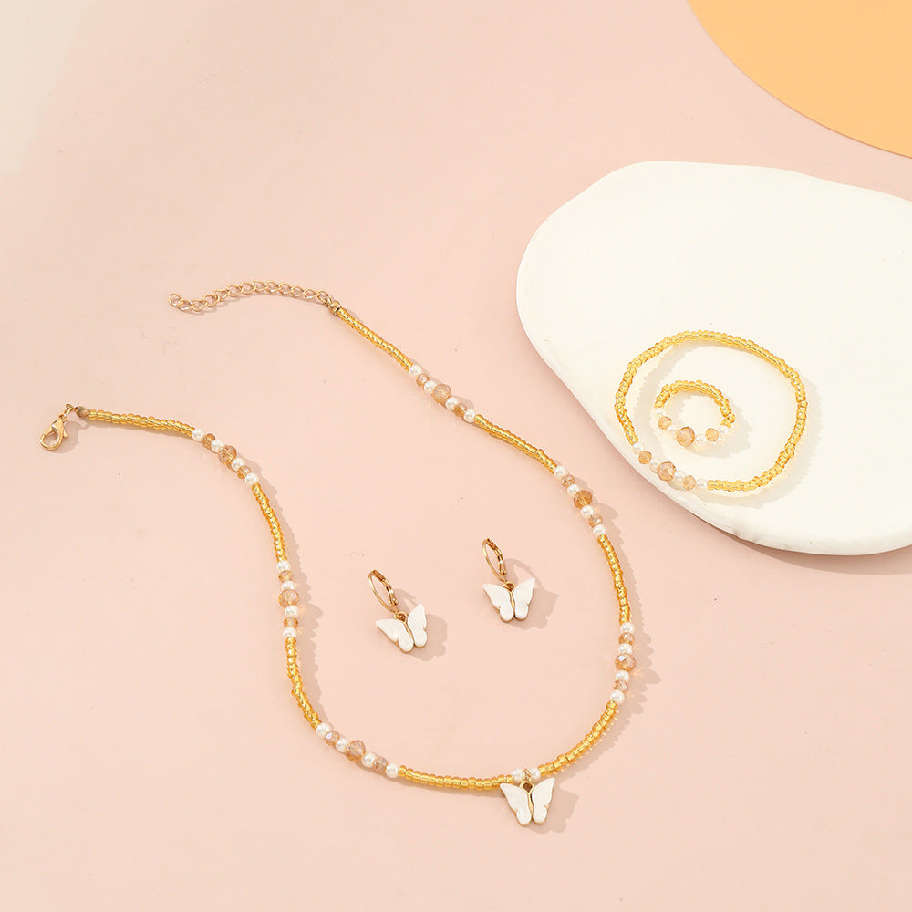 Set Collana Minimalista con Ciondoli a Farfalla e Cuore Smaltati per Bambini, Bracciale e Anello con Perline di Vetro, Catena a Sfere