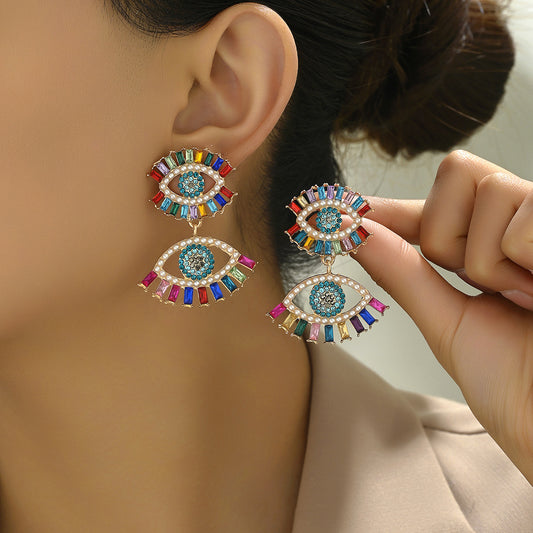 Pendientes minimalistas retro geométricos de aleación con incrustaciones de diamantes de imitación y diseño de ojo de ángel para mujer