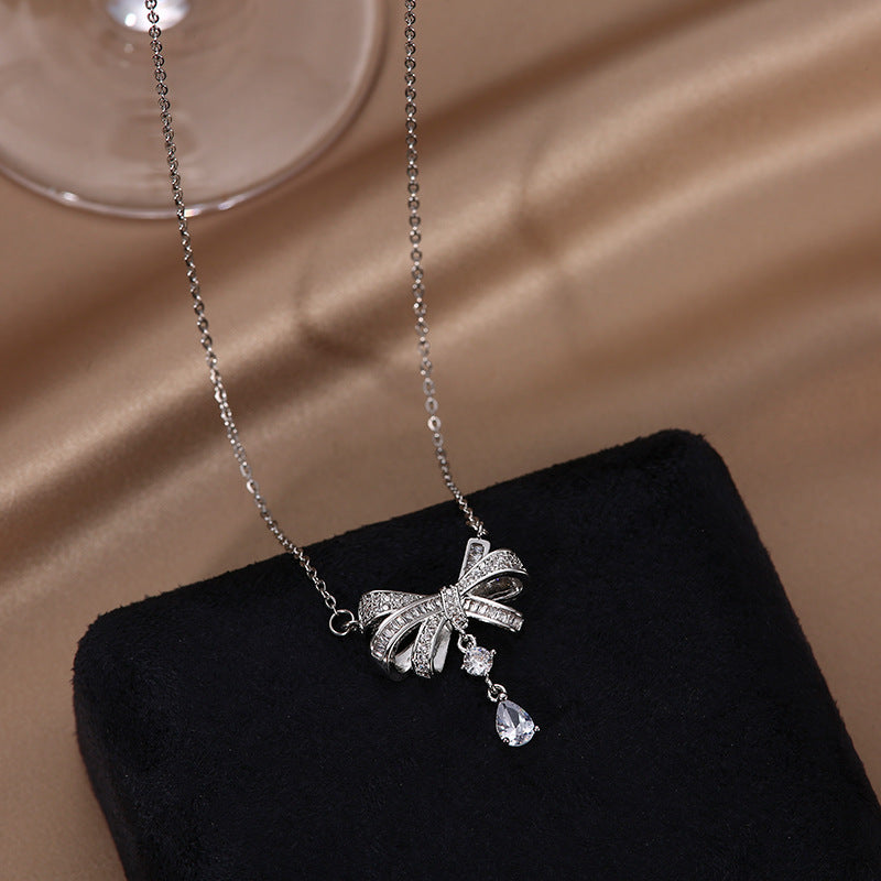 Sweet and Edgy Bow-Shaped Titanium Steel Necklace with Rhinestone Inlay for Women and Men