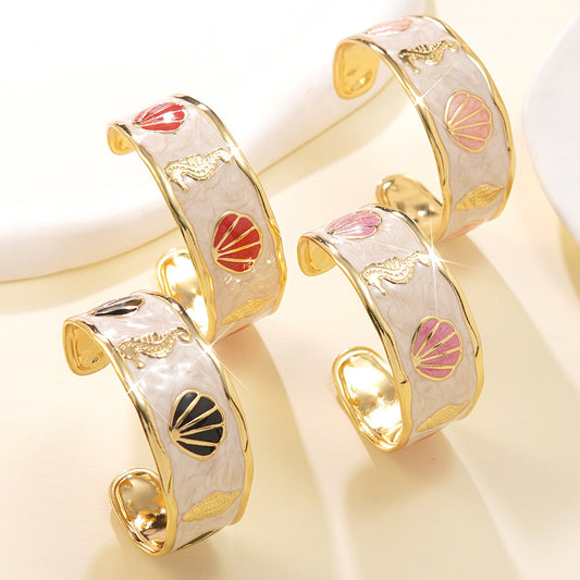 Pulsera de puño redonda de goteo de aceite de acero inoxidable con temática de concha marina