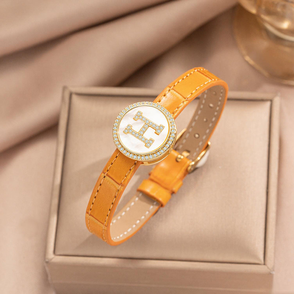 Pulsera de puño redonda chapada en oro de acero inoxidable minimalista con correa de cuero genuino para hombres y mujeres